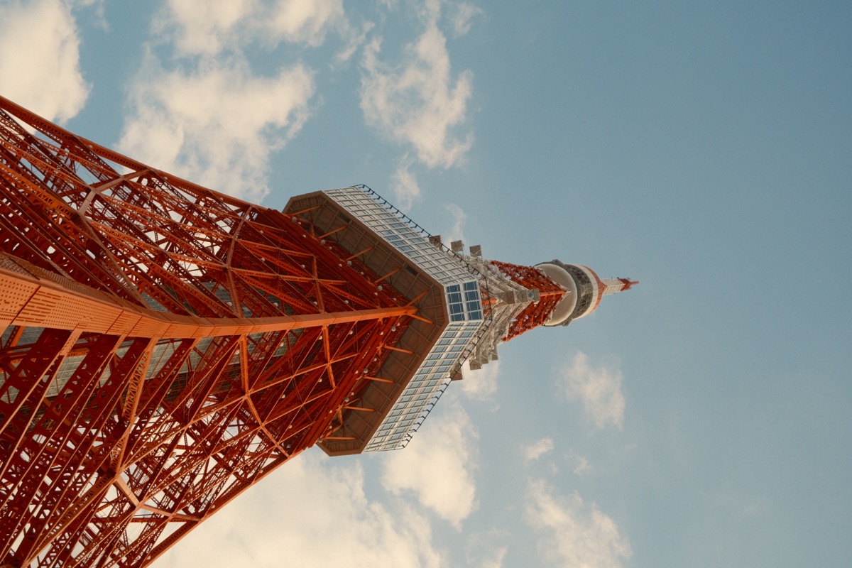 Tokyo Tower from below against a blue sky